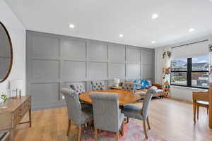 Dining room featuring a decorative wall, light wood finished floors, and recessed lighting