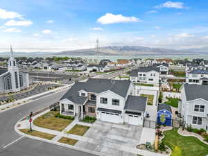 Drone / aerial view featuring a water and mountain view and a residential view
