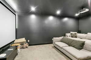Carpeted home theater room featuring recessed lighting