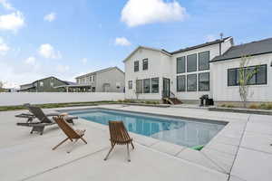 View of swimming pool featuring fence, a patio area, a fenced in pool, and entry steps