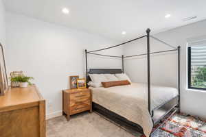 Bedroom featuring baseboards, light carpet, visible vents, and recessed lighting