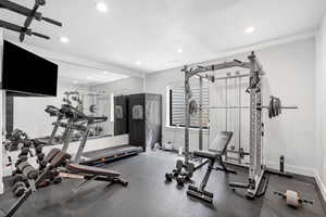 Exercise room with baseboards and recessed lighting