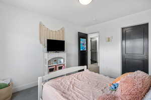 Bedroom featuring baseboards and carpet