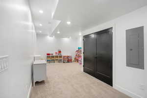 Game room with baseboards, recessed lighting, electric panel, and carpet