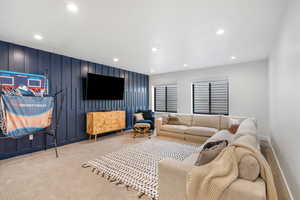 Carpeted living room with recessed lighting and baseboards