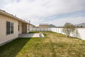 View of yard featuring a fenced backyard and a patio