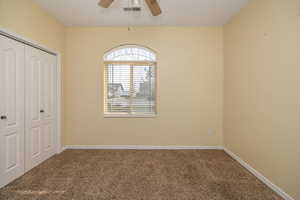 Bedroom 3 featuring a ceiling fan, a closet, carpet, baseboards, and visible vents