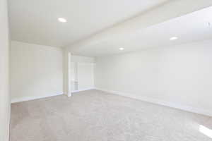 Interior space featuring baseboards, light carpet, and recessed lighting