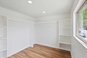 Empty room featuring recessed lighting, wood finished floors, and baseboards