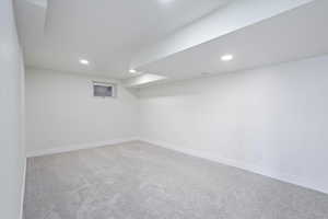 Finished below grade area with baseboards, carpet flooring, and recessed lighting
