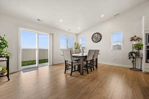 Dining space featuring a wealth of natural light, visible vents, and light wood-style flooring