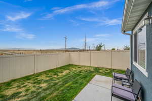 View of yard featuring a patio area, a fenced backyard, and a mountain view