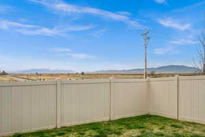 View of yard featuring fence and a mountain view