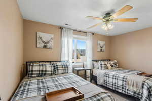 Bedroom with a ceiling fan and visible vents
