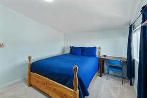 Carpeted bedroom with baseboards