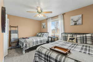 Bedroom with carpet flooring and a ceiling fan