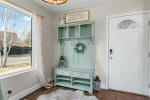 Mudroom featuring baseboards and dark wood finished floors