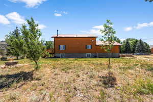 Exterior space featuring central AC, fence, and metal roof