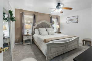 Bedroom featuring carpet floors, baseboards, and ceiling fan