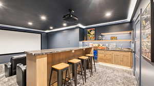 Cinema featuring light carpet, wine cooler, recessed lighting, and wet bar
