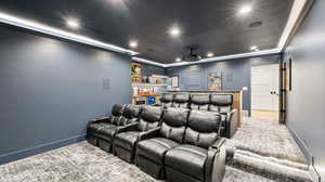 Home theater with baseboards, a bar, and recessed lighting