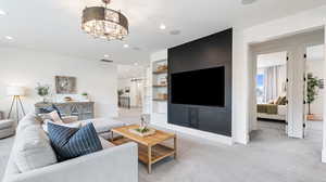 Living area featuring baseboards, visible vents, recessed lighting, a notable chandelier, and light colored carpet