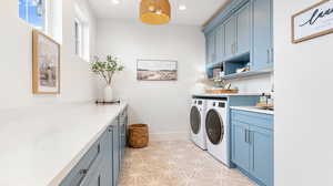 Laundry area with separate washer and dryer, baseboards, recessed lighting, and cabinet space
