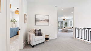 Living area with recessed lighting, baseboards, and light colored carpet