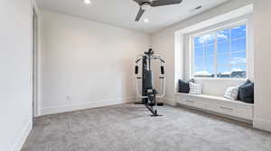 Exercise room featuring recessed lighting, visible vents, light colored carpet, and ceiling fan