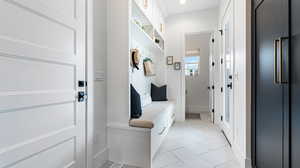 Mudroom with recessed lighting, baseboards, and light tile patterned floors