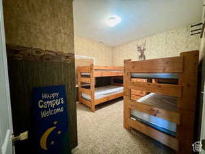 Bedroom featuring carpet flooring and a textured ceiling