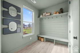 Mudroom with visible vents and wood finished floors