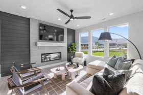 Living room featuring recessed lighting, a ceiling fan, and a fireplace