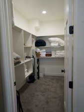 Spacious closet featuring carpet flooring