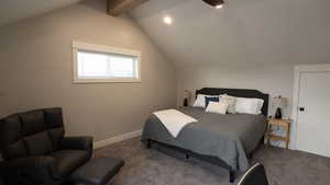 Carpeted bedroom with baseboards and lofted ceiling with beams