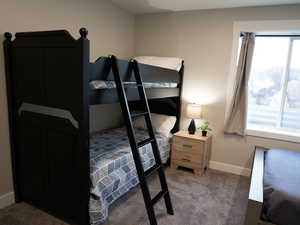 Carpeted bedroom with baseboards