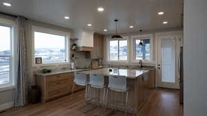 Kitchen featuring plenty of natural light, a kitchen island, dark wood-style floors, and visible vents