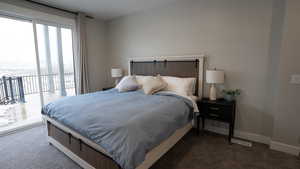 Bedroom featuring baseboards, access to exterior, and carpet