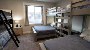 Bedroom with baseboards and carpet flooring