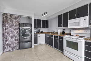 Modern kitchen offers laundry hook-ups and pantry storage.