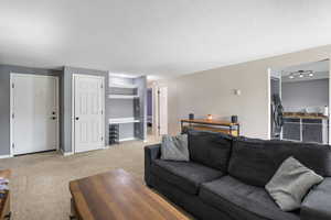 Living room featuring a coat closet and built-in desk with shelving.