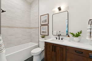 Bathroom featuring vanity, shower / bath combo, and tile patterned floors