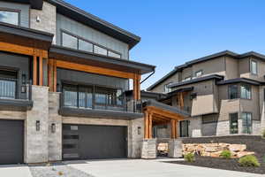View of building exterior featuring a garage and concrete driveway