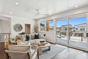 Living area featuring wood finished floors, recessed lighting, ceiling fan, and a residential view