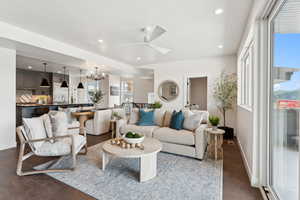 Living room featuring recessed lighting, a chandelier, a ceiling fan, and dark wood finished floors