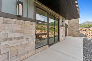 Entrance to property featuring stone siding