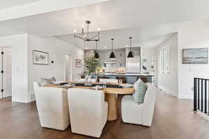 Dining area featuring a chandelier, wood finished floors, and recessed lighting