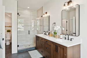 Full bathroom with double vanity, a stall shower, tile patterned floors, and recessed lighting
