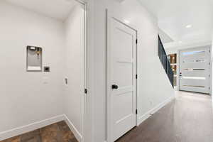 Hall featuring stairs and recessed lighting