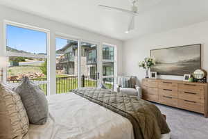 Bedroom with carpet flooring, access to exterior, a ceiling fan, and recessed lighting